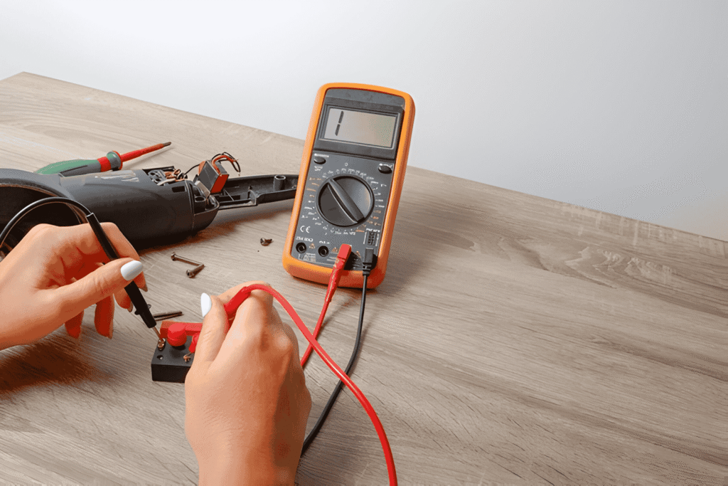 A multimeter set to continuity mode with probes touching a wire to check for circuit connection